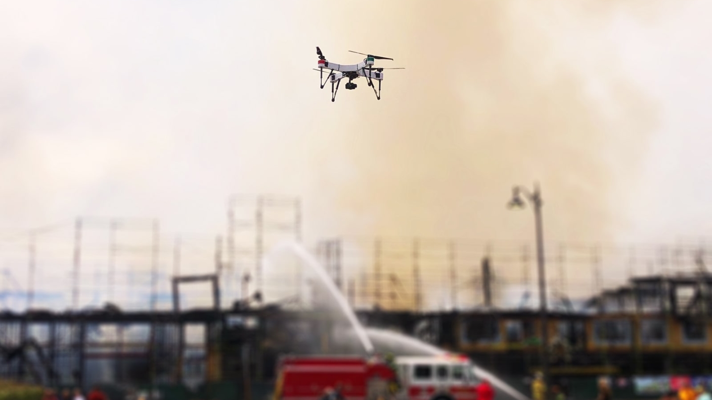 Drone flying over a fire engine at a burn scene