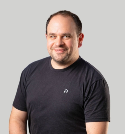 headshot of man in black tshirt