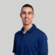 headshot of man on gray background