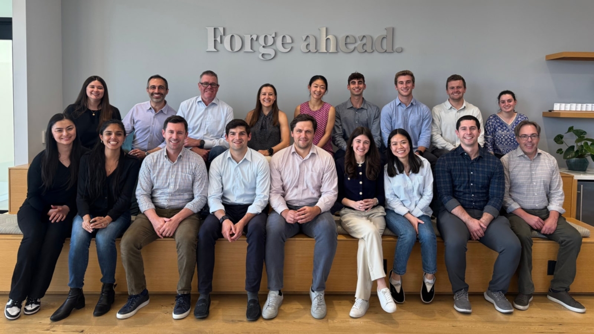 Group sitting in front of a sign that says BVP Forge